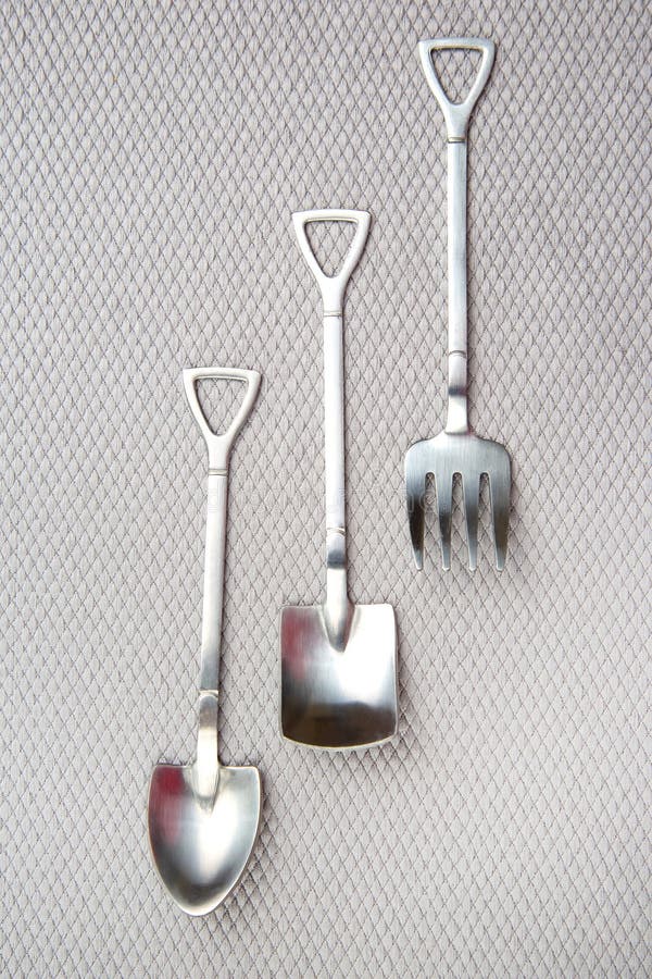 Decorative Fork and Spoons in the Form of Spades on a Gray Background
