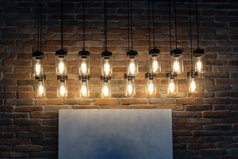 Decorative Light Bulbs Hanging in a Pattern Way Against Brick Wall