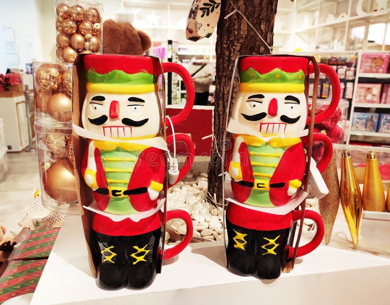 Decorative multicolored ceramic mug in the form of New Year\'s soldier nutcracker in the shop window stock image