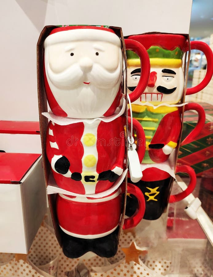 Decorative multicolored ceramic mug in the form of Santa Claus in the shop window stock image