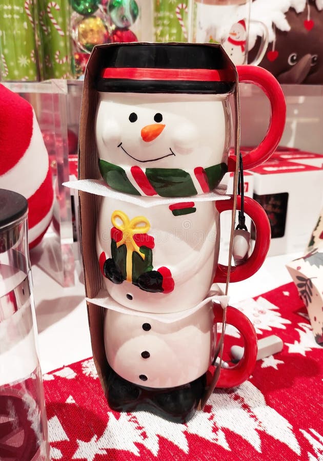 Decorative multicolored ceramic mug in the form of snowman in the shop window royalty free stock image