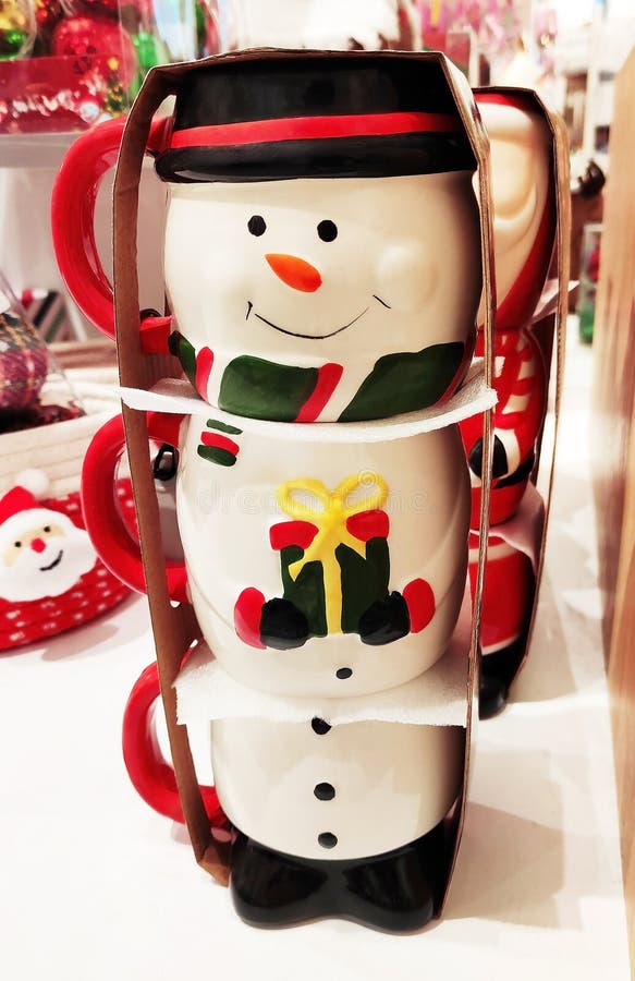 Decorative multicolored ceramic mug in the form of snowman in the shop window stock image