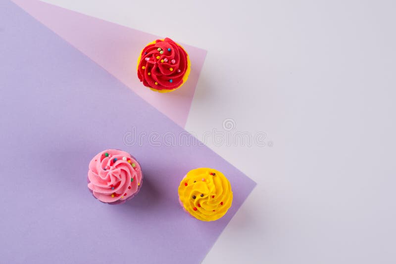 Decorative multicolored sugar cupcakes on light background stock photography