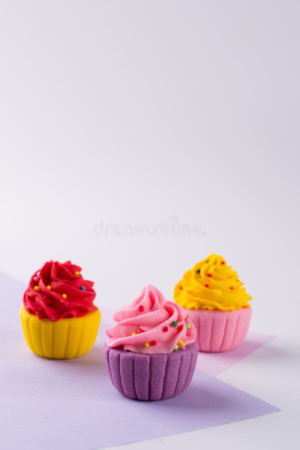 Decorative multicolored sugar cupcakes on light background stock photo