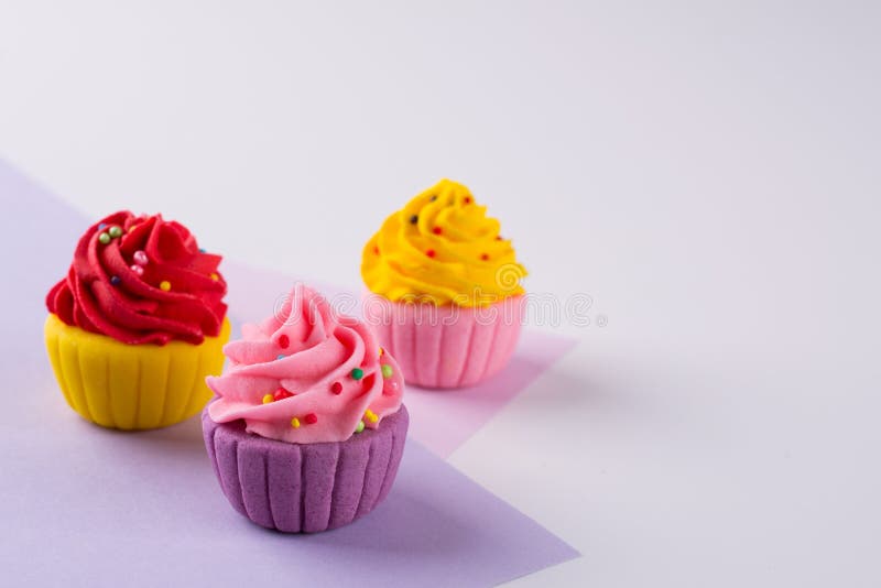 Decorative multicolored sugar cupcakes on light background stock images