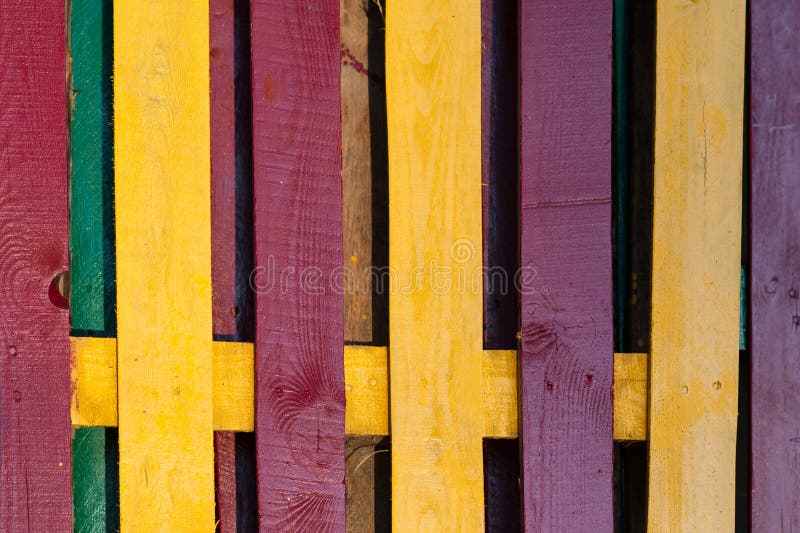 Decorative multicolored wooden fence as a background stock photography