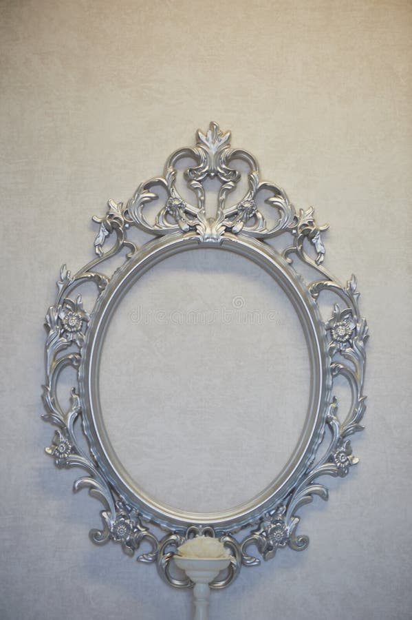 Decorative Oval Frame Hanging on the Gray Wall. Classic Decor, Framing