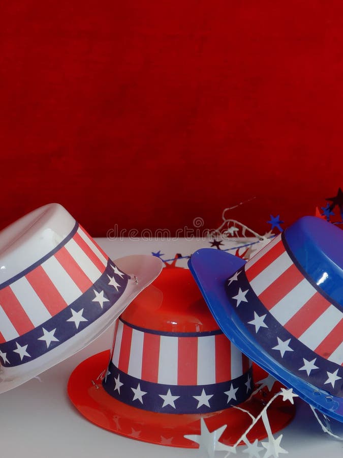 Three decorative party hats in patriotic colors of red, white, and blue colors and hatbands with the Stars and Stripes. Three decorative party hats in patriotic colors of red, white, and blue colors and hatbands with the Stars and Stripes