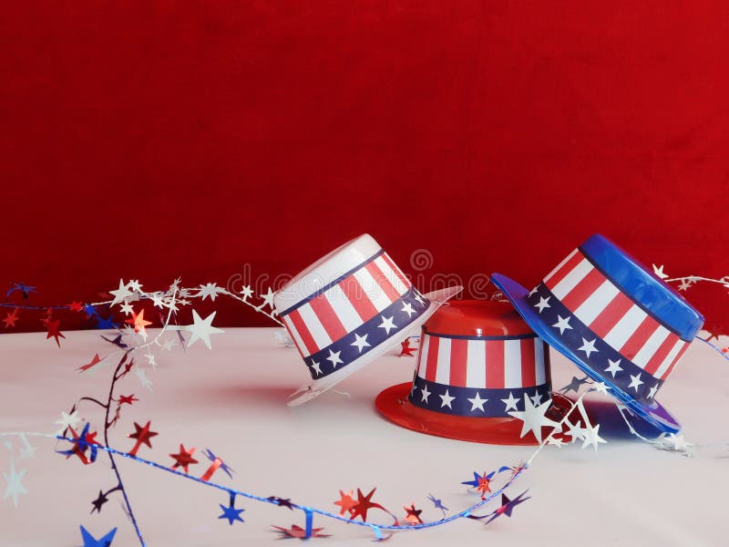 Three decorative party hats in patriotic colors of red, white, and blue colors and hatbands with the Stars and Stripes. Three decorative party hats in patriotic colors of red, white, and blue colors and hatbands with the Stars and Stripes