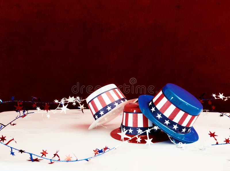 Three decorative party hats in patriotic colors of red, white, and blue colors and hatbands with the Stars and Stripes. Three decorative party hats in patriotic colors of red, white, and blue colors and hatbands with the Stars and Stripes