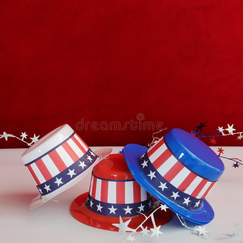 Three decorative party hats in patriotic colors of red, white, and blue colors and hatbands with the Stars and Stripes. Three decorative party hats in patriotic colors of red, white, and blue colors and hatbands with the Stars and Stripes