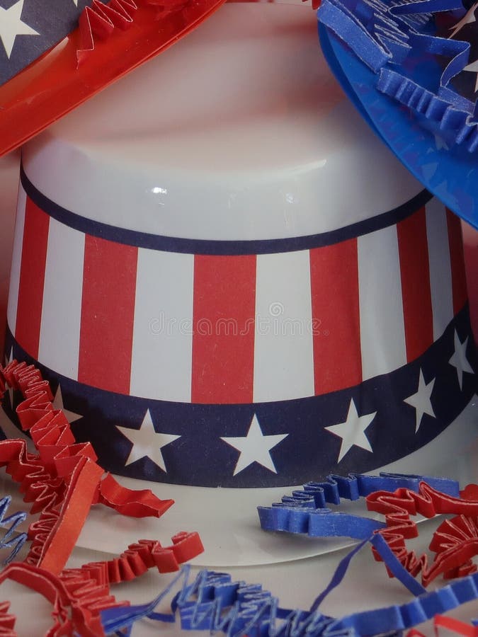 Three decorative party hats in patriotic colors of red, white, and blue colors and hatbands with the Stars and Stripes. Three decorative party hats in patriotic colors of red, white, and blue colors and hatbands with the Stars and Stripes