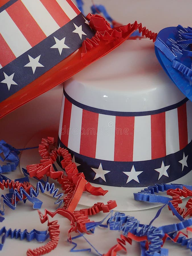 Three decorative party hats in patriotic colors of red, white, and blue colors and hatbands with the Stars and Stripes. Three decorative party hats in patriotic colors of red, white, and blue colors and hatbands with the Stars and Stripes