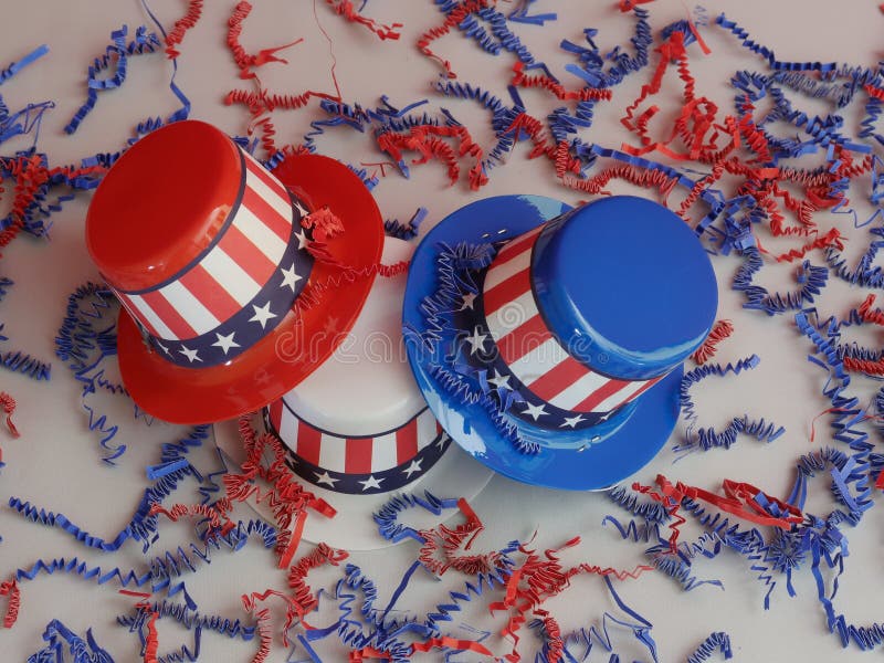 Three decorative party hats in patriotic colors of red, white, and blue colors and hatbands with the Stars and Stripes. Three decorative party hats in patriotic colors of red, white, and blue colors and hatbands with the Stars and Stripes