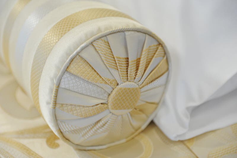 Decorative Pillowcushion of Golden Fabric on the Bed. Closeup Stock