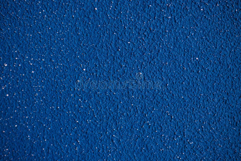 Decorative Plaster and Blue Paint on the Wall.Rough Uneven Surface