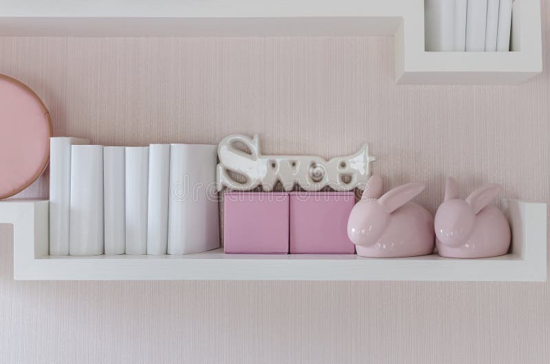 Decorative Shelf on Pink Wall with Rabbits Ceramic and Word Stock Photo