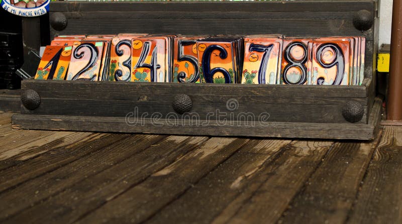 Ceramic decorative tiles with digits in wooden box