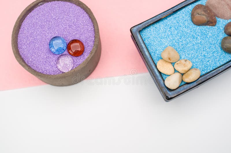 Decorative Vases with Colored Sand and Pebbles on a White Background