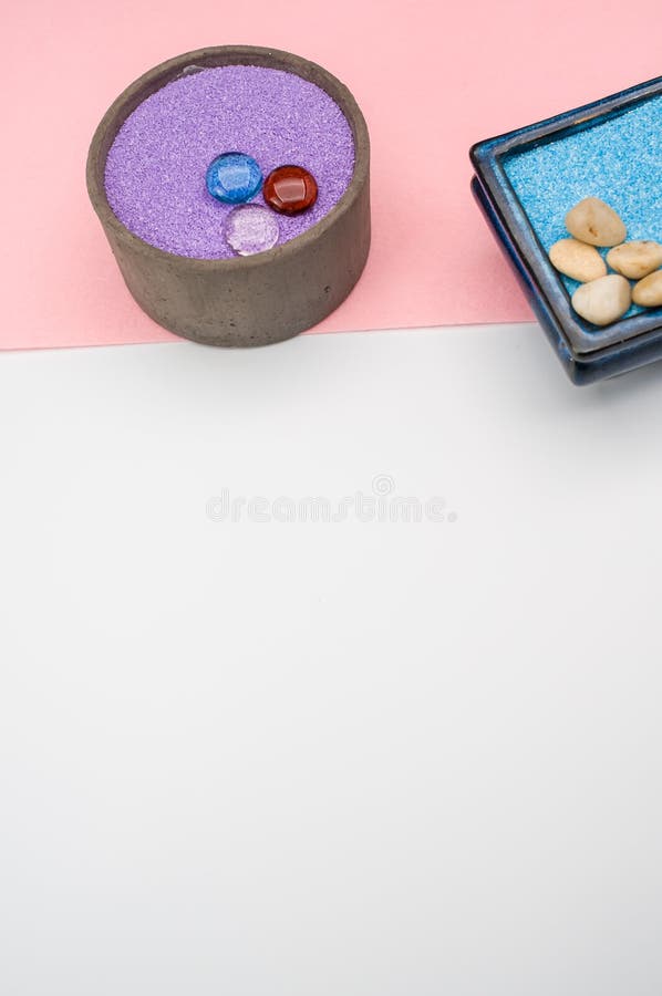 Decorative Vases with Colored Sand and Pebbles on a White Background
