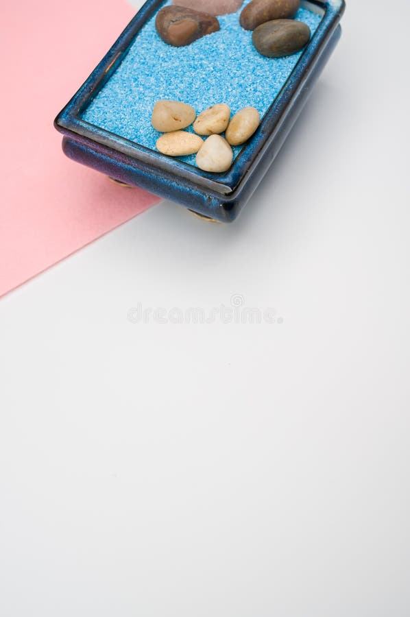 Decorative Vases with Colored Sand and Pebbles on a White Background
