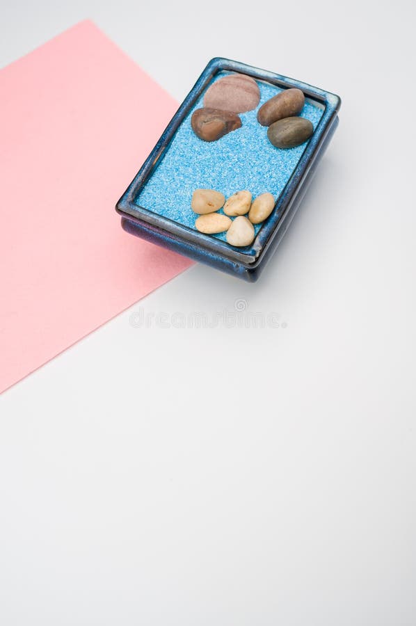 Decorative Vases with Colored Sand and Pebbles on a White Background