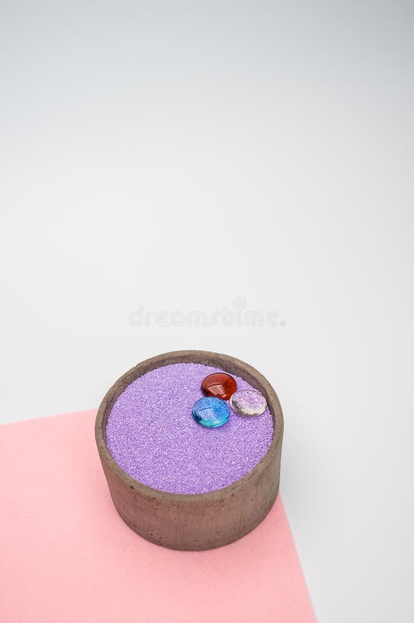 Decorative Vases with Colored Sand and Pebbles on a White Background