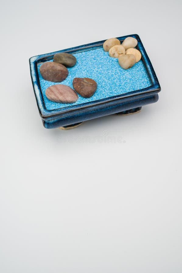 Decorative Vases with Colored Sand and Pebbles on a White Background