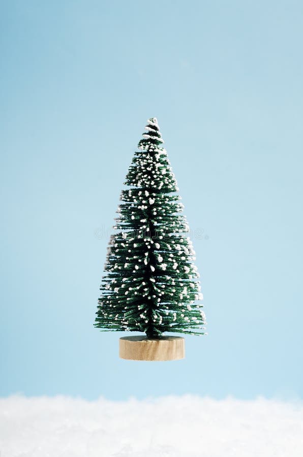 Decorative Xmas fir tree isolated on blue background. New year festive vertical backdrop. Christmas holiday creative greeting card stock photo Decorative Xmas fir tree isolated on blue background. New year festive vertical backdrop. Christmas holiday creative greeting card stock photo