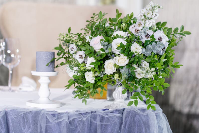 Decoração bonita e excelente da celebração do casamento Banquet a tabela servida com uma toalha de mesa azul, placas e imagem de stock Decoração bonita e excelente da celebração do casamento Banquet a tabela servida com uma toalha de mesa azul, placas e imagem de stock
