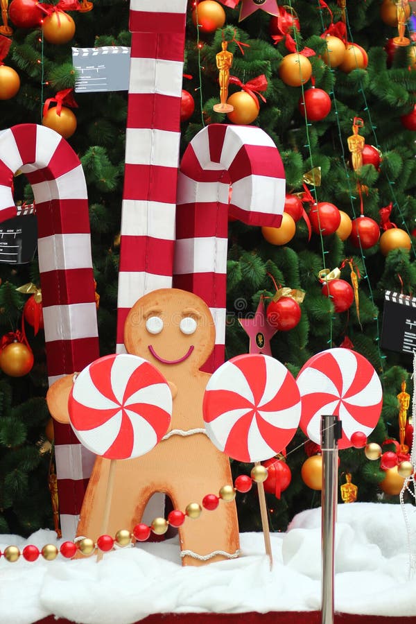 Decoração da árvore de Natal, homem de pão-de-espécie gigante, bastões de doces e pirulitos fotografia de stock Decoração da árvore de Natal, homem de pão-de-espécie gigante, bastões de doces e pirulitos fotografia de stock