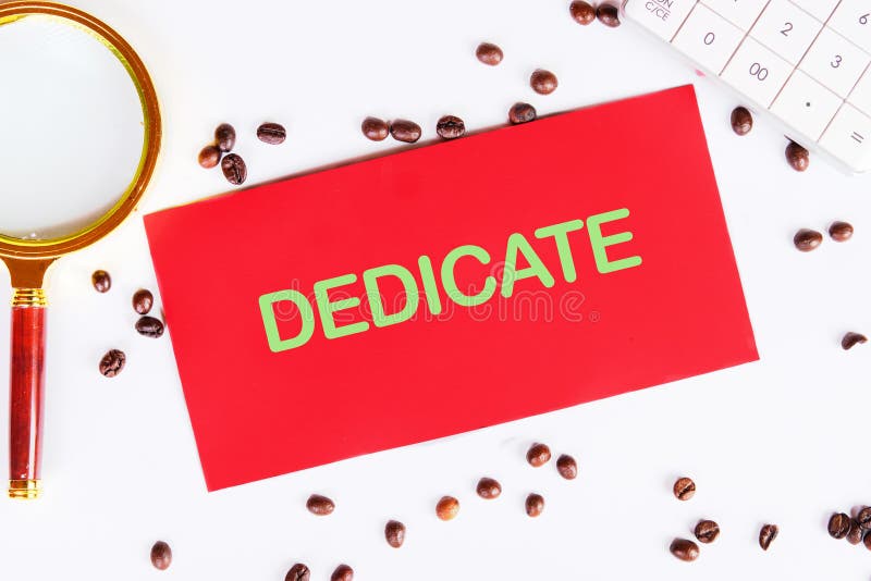DEDICATE word written on a red card on a light background. Conceptual text royalty free stock images