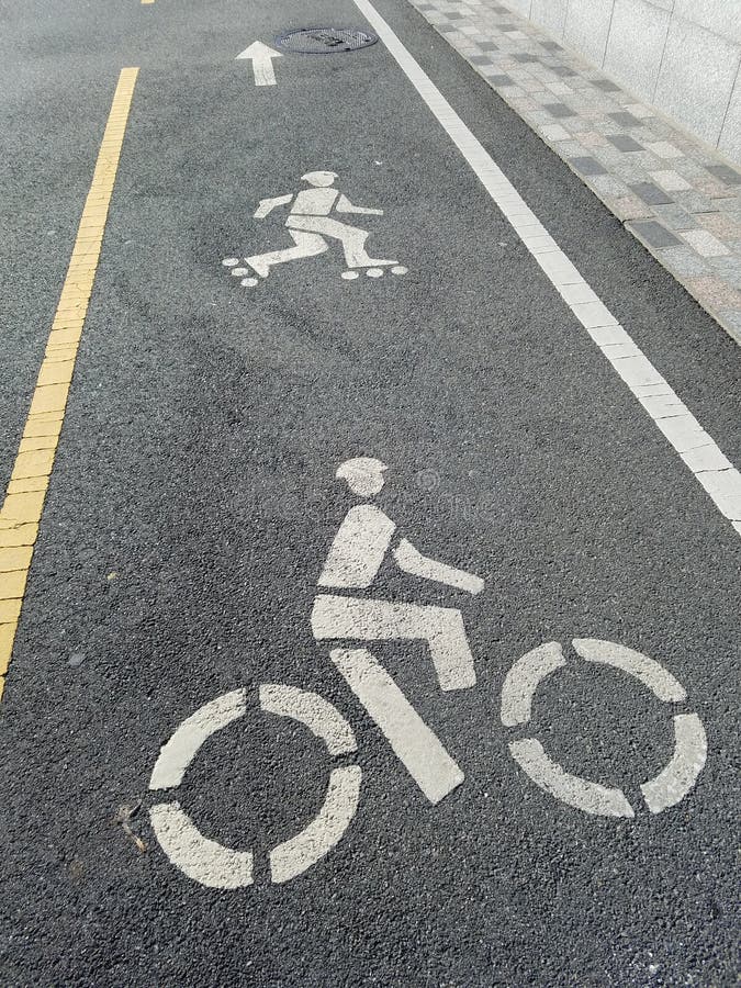 Dedicated separate safety lane for anyone getting around by skates or rollerblades or bicycles. Skating and rollerblading and cycling encouraged as means of transport. Lane marking indicates where riders need to follow. Safety helmet in the painted figures. Pedestrians have separate area to walk. Gray tiles create extra high visibility buffer for clear delineation at top speed. NYC wants you to share the road and stay safe. Dedicated separate safety lane for anyone getting around by skates or rollerblades or bicycles. Skating and rollerblading and cycling encouraged as means of transport. Lane marking indicates where riders need to follow. Safety helmet in the painted figures. Pedestrians have separate area to walk. Gray tiles create extra high visibility buffer for clear delineation at top speed. NYC wants you to share the road and stay safe.