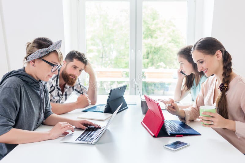 Dedicated young woman editing a document in a modern office space