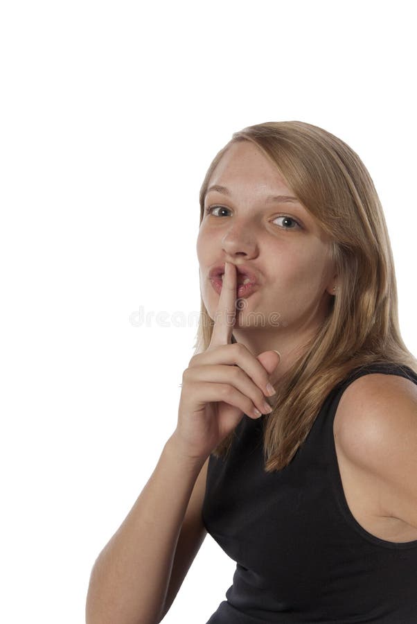 Dedo de las expresiones faciales del adolescente sobre boca fotografía de archivo Dedo de las expresiones faciales del adolescente sobre boca fotografía de archivo