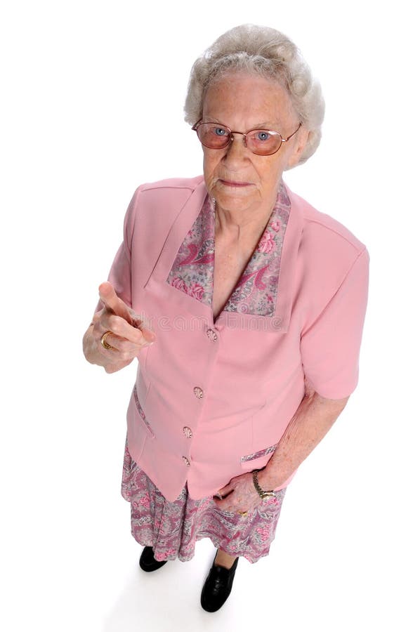 Portrait of serious senior woman pointing finger isolated over white. Portrait of serious senior woman pointing finger isolated over white