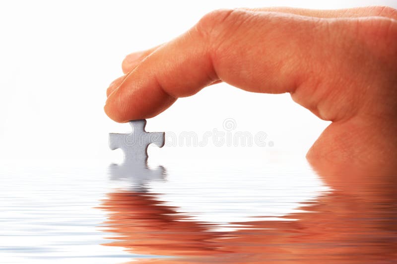 Finger and puzzle in water on white. Finger and puzzle in water on white