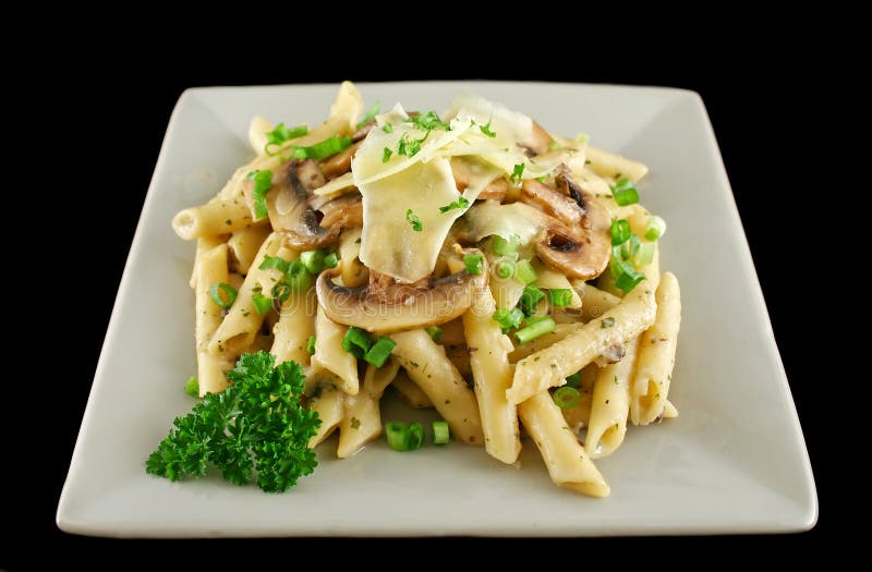 Creamy mushroom penne pasta with shredded cheese. Creamy mushroom penne pasta with shredded cheese.