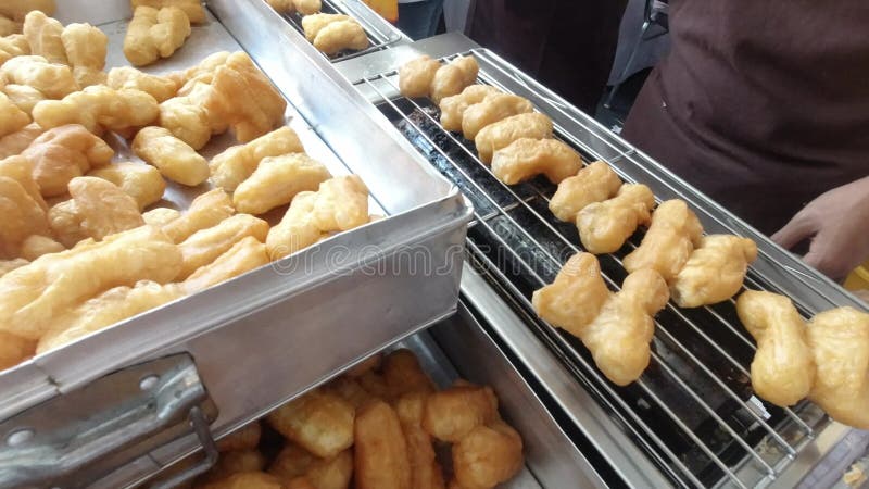 Deep fried dough stick grilling on BBQ Strove