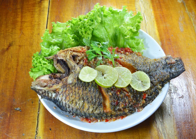 Deep Fried Mango Fish Dressing Sweet Chili Sauce and Slice Lemon Stock