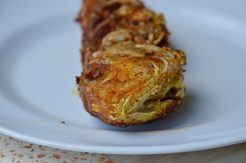 Deep Fried Red Snapper with Turmeric Powder on Plate Stock Photo