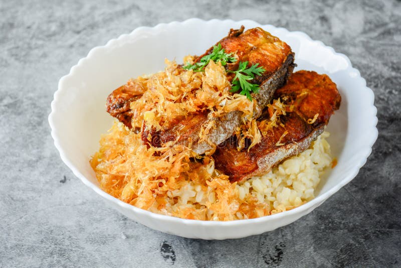Deep fried sliced Pangasius fish with garlic stock image Deep fried sliced Pangasius fish with garlic stock image
