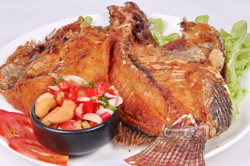Deep Fried Tilapia with Spicy and Sour Herb Salad . Stock Photo Image