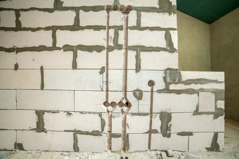 Deep Grooves and Holes in White Brick Wall Made for Installation of