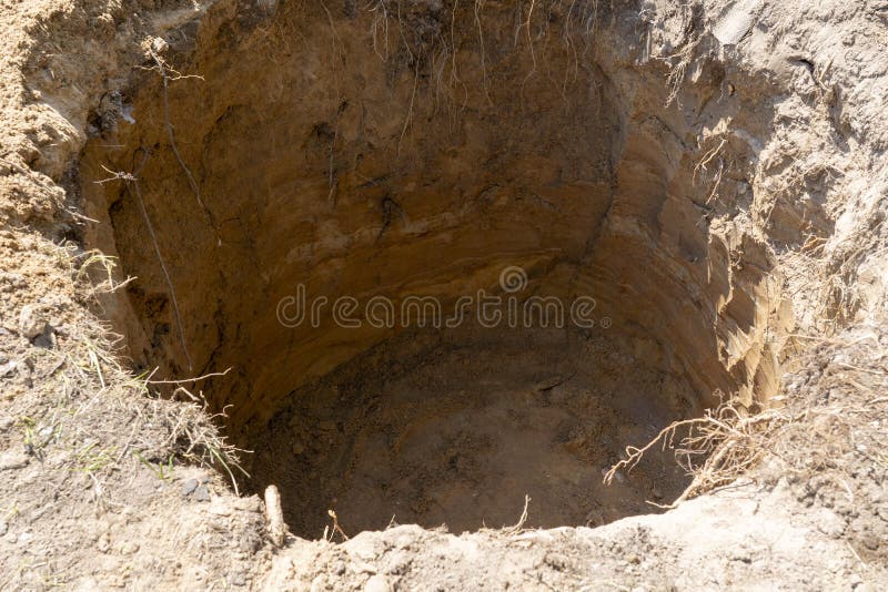 Deep Dirt Hole In Ground Or Lawn Stock Photo - Download Image Now