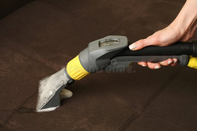 Deep Professional Cleaning of Sofa with Vaccum Cleaner Stock Photo