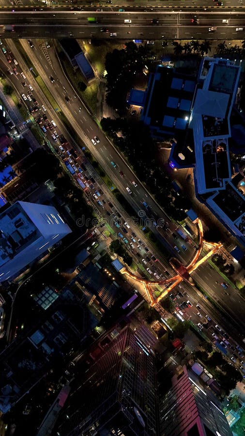 Aerial Drone View of Jakarta Cityscape at the iconic Pinisi Pedestrian Bridge