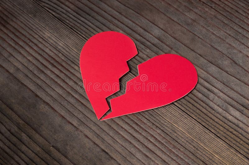 Close up of paper broken heart on wooden background. Close up of paper broken heart on wooden background