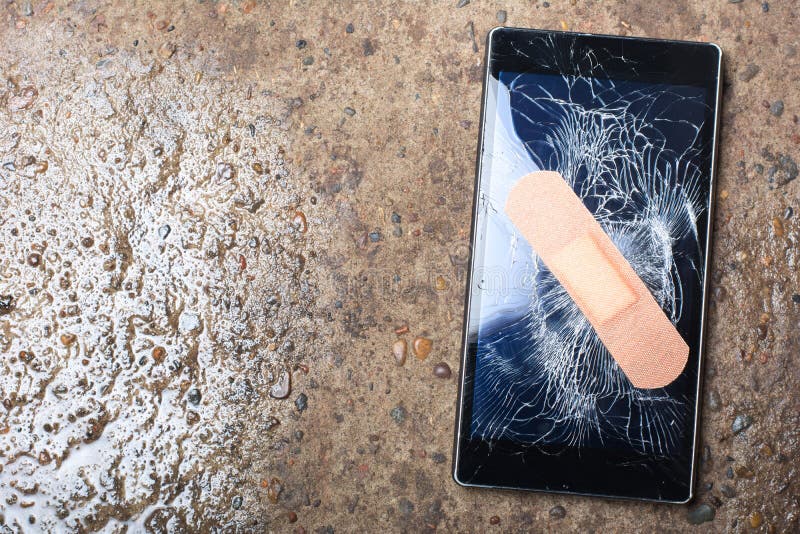 Broken Smart Phone with cracked screen fixed with plaster. Concept. Broken Smart Phone with cracked screen fixed with plaster. Concept