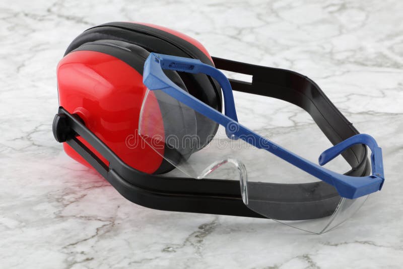 Defensores de orejas y gafas de seguridad en una superficie de mármol